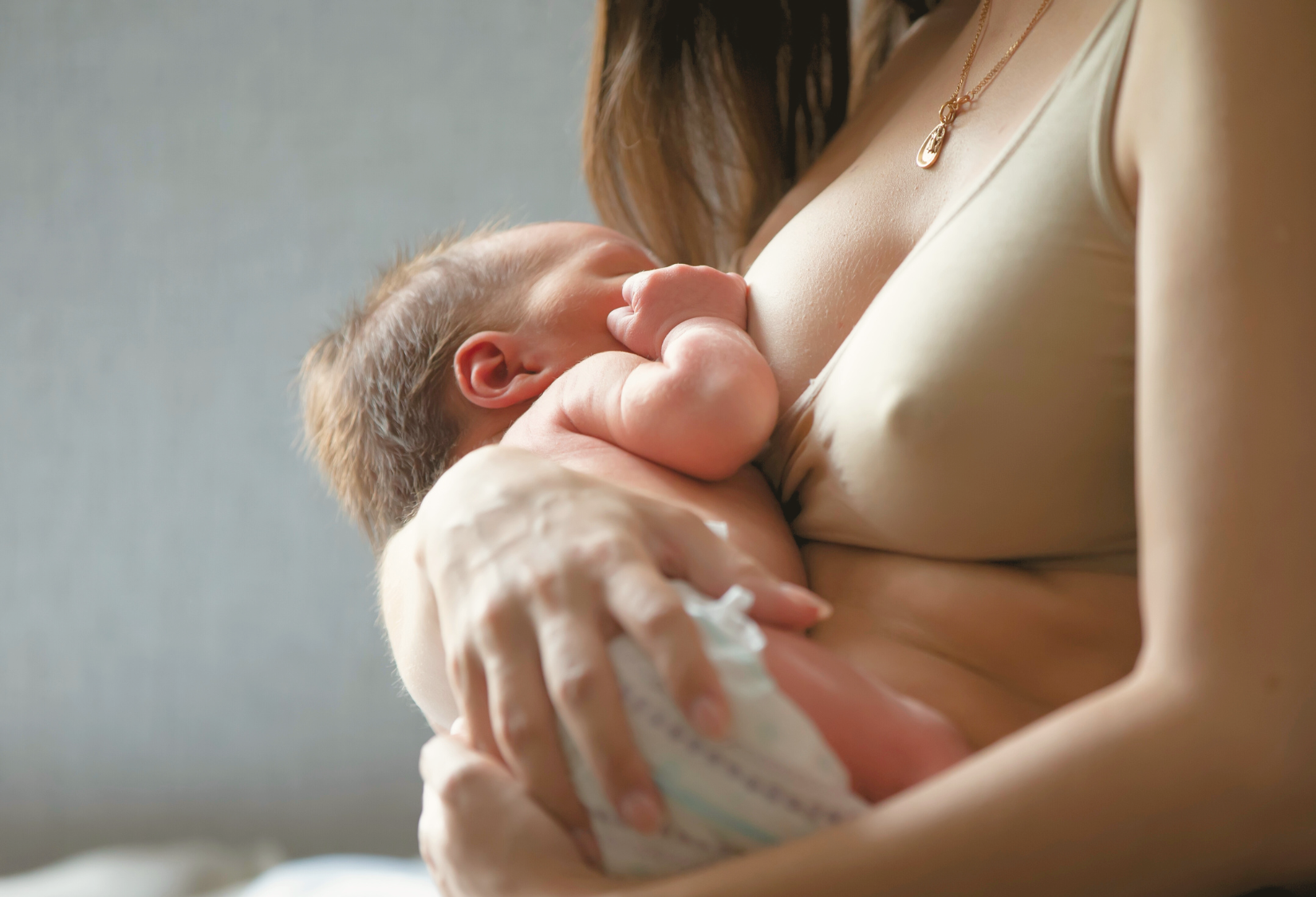 Mother holding her baby while she is breastfeading