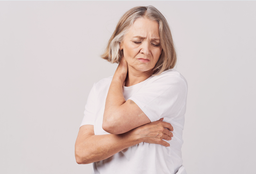 chronic pain clothing: a woman holding her neck in discomfort