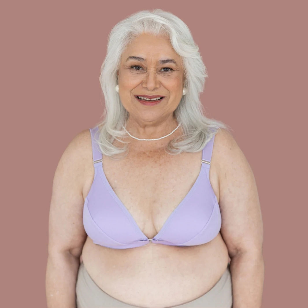 Silver haired model wearing the springrose velcro front closure bra in lilac