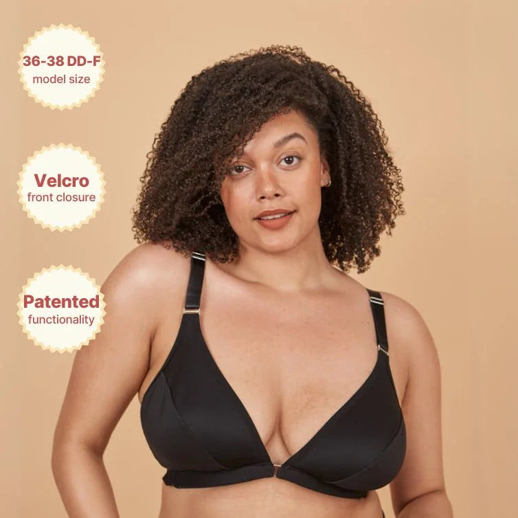 Young woman wearing the Springrose adaptive velcro front closure bra in black while smiling. The image highlights the size, the velcro front closure, and patented functionality.