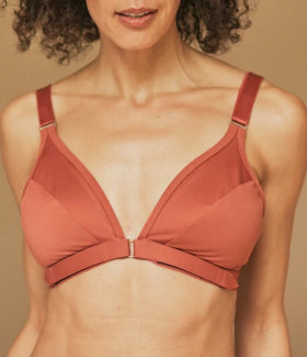 A close up of the Springrose adaptive bra in terracotta, including the velcro bra part, on a mature model